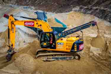 Sand being extracted by machines from a live working quarry in Dorset